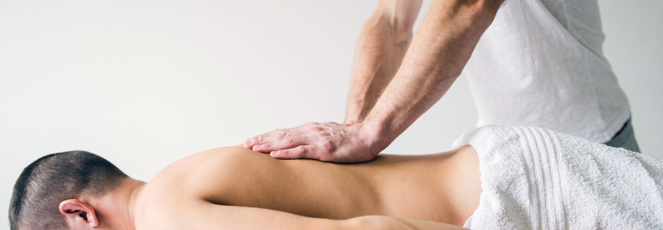Message therapist giving a man a massage